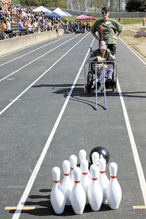 In the Motor Development area of the Special Olympics, Sean Hargett smiles as he is given cheers, as he knocked down all ten of the bowling pins. It was a happy moment for this special young man.