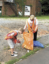 Cub Scout and Mom  picking up litter.
