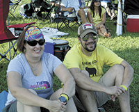 Kelly and Joel Baber sat on the grass, among many others, as they listened to â€œBig Daddy Loveâ€ perform.