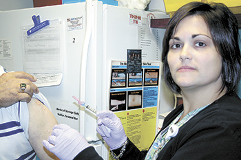 Nicole Newton, RN, gets ready to administer a flu shot at the Cleveland County Health Department