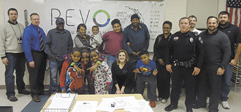 Children from the Boys & Girls Club who received a computer are joined by parents, Revo Communications employes and others who made the class possible.