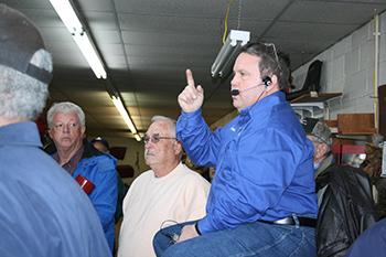 Tony Furr of Classic Auctions calls out items and takes the bids at Wilson Tractor Supply.
