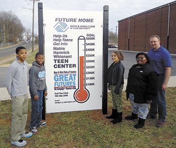 Members from Boys and Girls Club of Cleveland County are pictured with the Club's Executive Director Josh Propst at the new thermometer sign dedicated to the $500,000 goal.