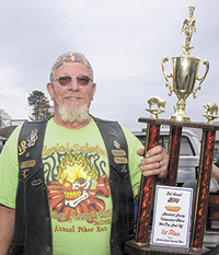 Jerry "Peg Leg" Fairchild won the Hot Dog Cook-off and is shown here with his trophy.