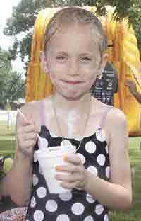 First grader, Hedi Pyatte enjoys an icy treat. (Below Right) Fifth grader, Joshua Coburn is all foamed up.
