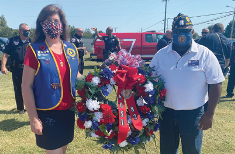 Mrs. Rebecca Higgins, President Unit 82, and Post 82 Commander Victor Darville placed a wreath at the base of the fl ag pole to honor victims of 9/11, at Monday's, Sept. 7, 2020, Remembrance Ceremony
