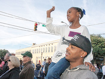 Oundry Petty lifts his daughter Aubrey up for a better advantage to watch the 7th Annual Little Miss Livermush Pageant during the Mush, Music, and Mutts Festival in Uptown Shelby.      Photo by Jeff Melton