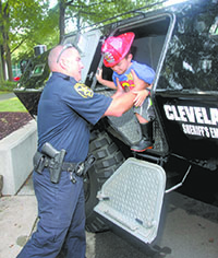 Cleveland County Sheriff\'s Deputy, Kirk Smith, helps Mario Leon out of the Department\'s SERT Armored Vehicle.