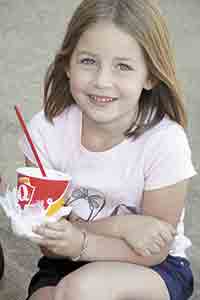 Five-year-old Baylee Horton enjoys her ice cream during the Car Show festivities.